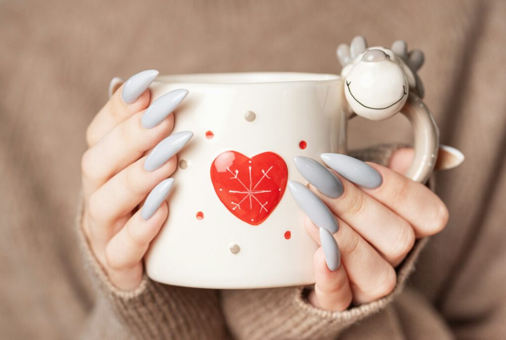 Close up of woman's hand with grey nail polish